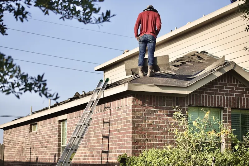 Professional roofer working on a residential roof in Moosup